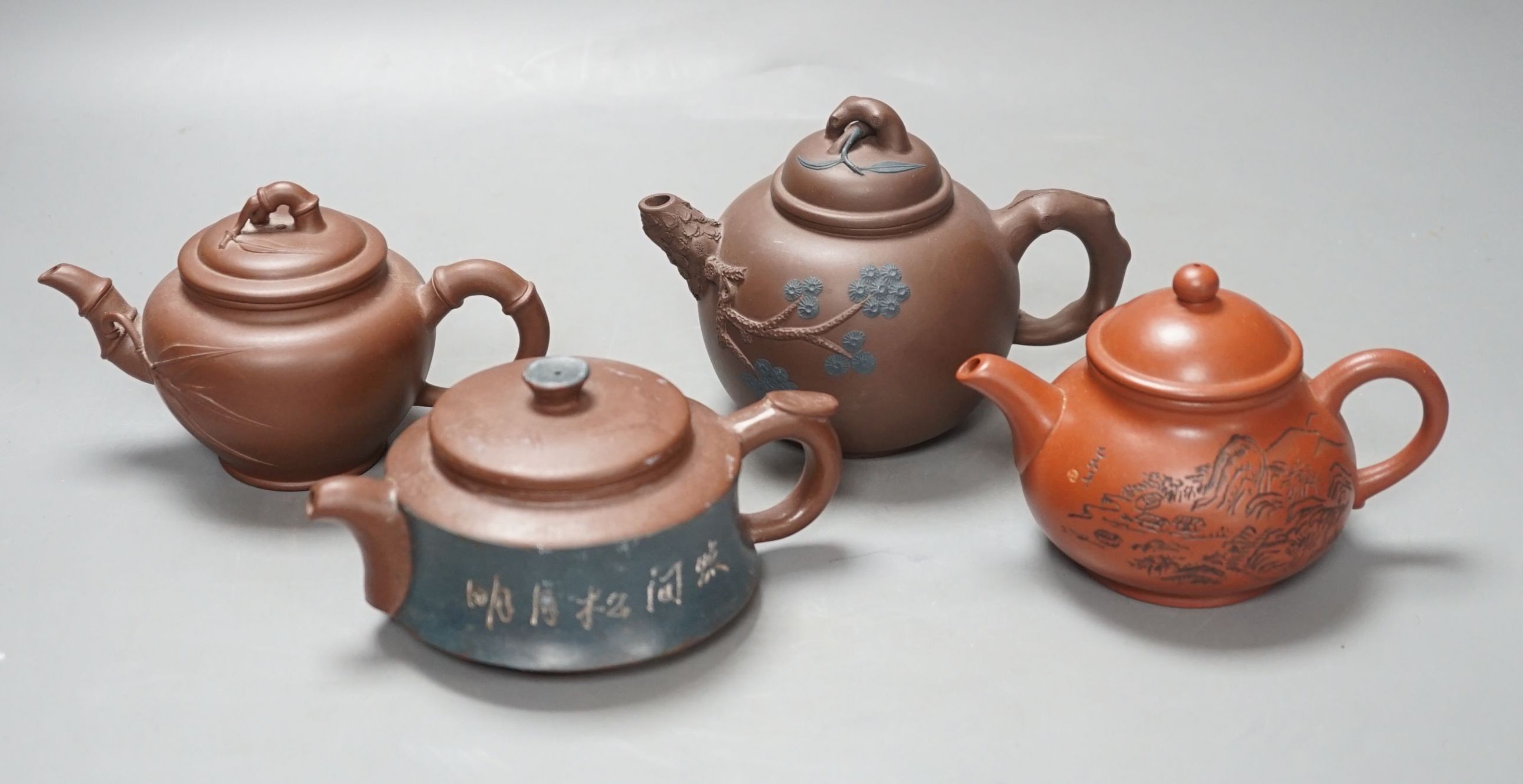 A group of four Yixing pottery teapots - tallest 11cm